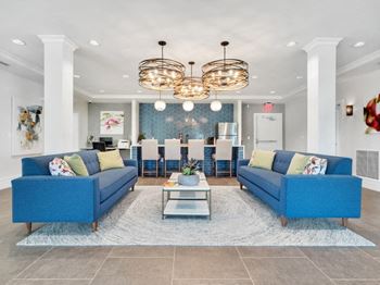a living room with blue couches and a coffee table